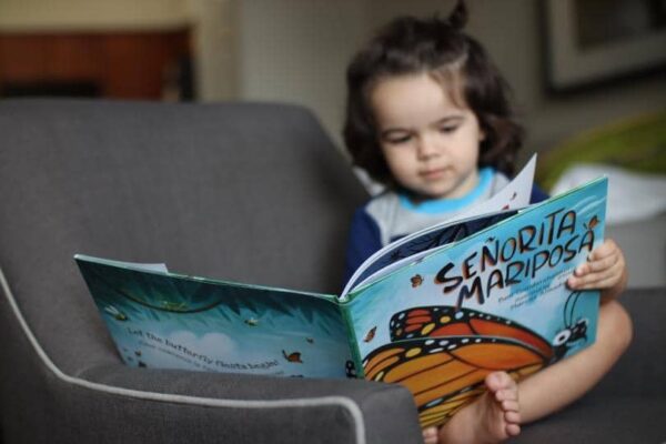 Child Reading Mariposa
